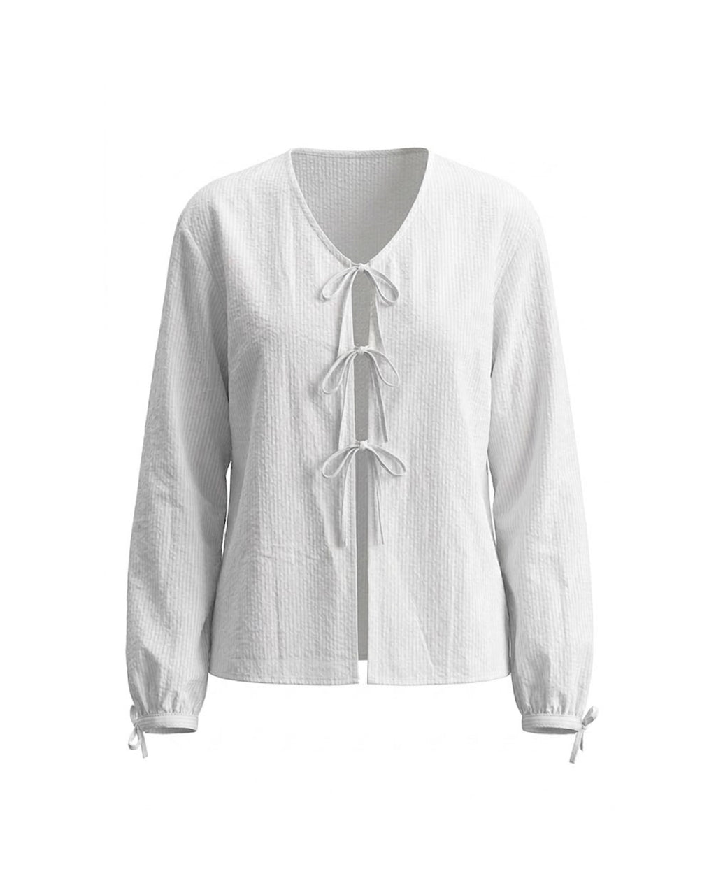 Blusa blanca texturizada con lazadas y mangas abullonadas